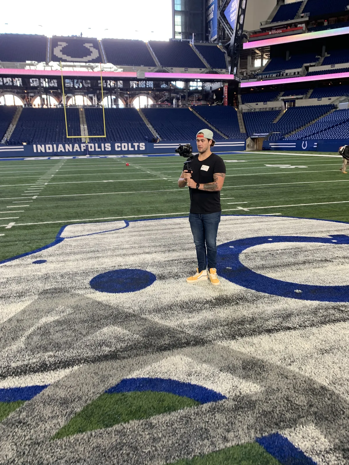 Kyle Williams filming on the field at Lucas Oil Stadium in Indianapolis